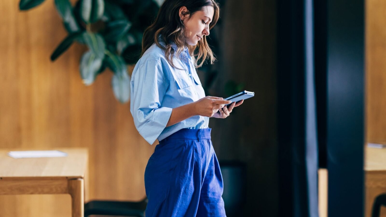 woman investing looking at her phone