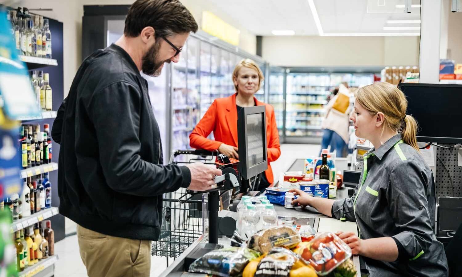 man stands at cashier grocery stores