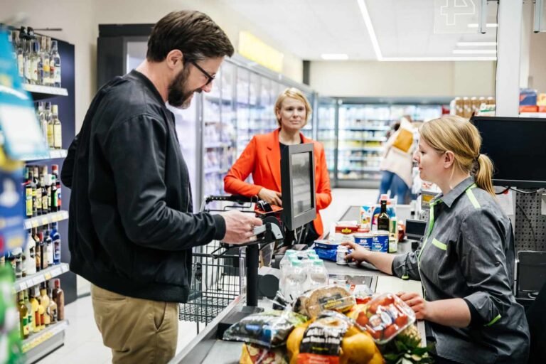 man stands at cashier grocery stores